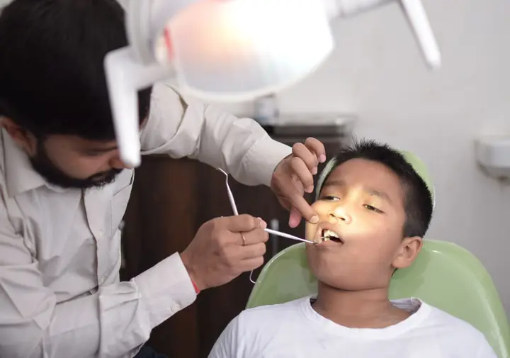 Illustrative photograph of a child receiving a dental checkup